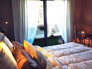 a bedroom with a bed in front of a window at Ivy and Roses Boutique Apartments in Canberra