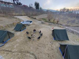 an aerial view of a group of animals and tents at Chanshal Camp in Khashdhār