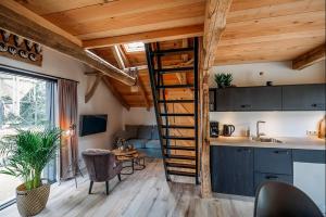 a kitchen with a spiral staircase in a tiny house at Vakantiewoning Lemselermaten in Weerselo