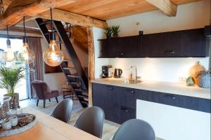 a kitchen with a table and chairs and a staircase at Vakantiewoning Lemselermaten in Weerselo +4 photos
