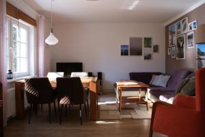 a living room with a table and chairs and a couch at Ferienhaus Lilli in Pruchten