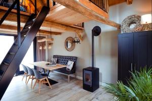a dining room with a table and a wood stove at Vakantiewoning Lemselermaten in Weerselo
