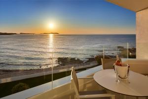 a room with a table and a view of the ocean at Can Salia 4 Stars Sup in San Antonio Bay