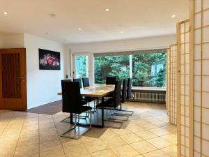 a dining room with a table and black chairs at Nice Apartments in Gelnhausen in Gelnhausen