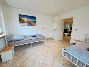 a bedroom with two beds and a table at Nice Apartments in Gelnhausen in Gelnhausen
