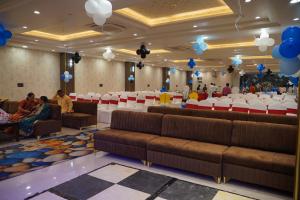 a banquet hall with couches and tables and balloons at Shagun Hotel & Banquet in Lucknow
