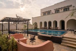 a resort with a swimming pool and a building at Niwasa - A Luxury Boutique Stay, Udaipur in Udaipur