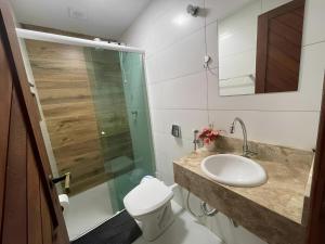 a bathroom with a toilet and a sink and a shower at Hostel House Santinho in Florianópolis