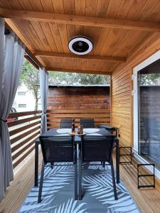 a ping pong table on the deck of a house at Moon apartments in Pakoštane