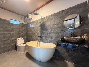 a bathroom with a large tub and a sink at Trang An Green Retreat Homestay in Ninh Binh +46 photos