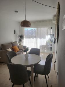 a living room with a table and chairs at ESPIGALL in Vilanova i la Geltrú