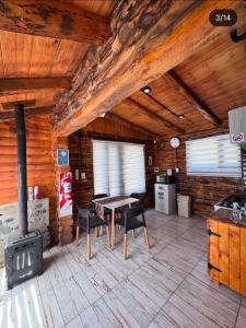 a kitchen with a table and a stove in a cabin at cabañas de montaña Triskel in Aluminé