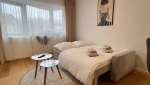 a bedroom with a bed with two towels on it at VApartment Nova Vajnorska , private parking in Koliba