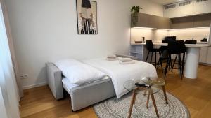 a small room with a bed and a table at VApartment Nova Vajnorska , private parking in Koliba