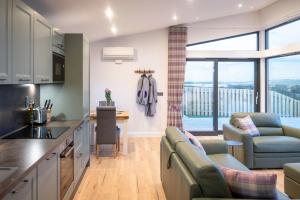 a kitchen and living room with a view of the city at Bennachie Lodge in Huntly