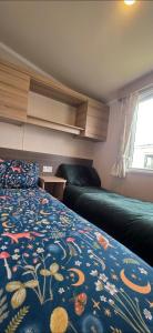 a bedroom with a bed and a couch and a window at Sea view 1 in Heysham +24 photos