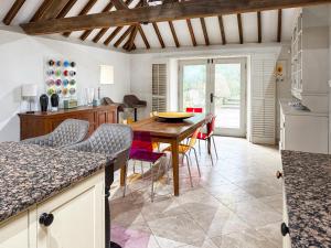 a kitchen and dining room with a wooden table and chairs at Church Barn in Olney +27 photos