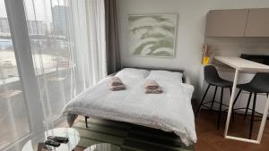 a bedroom with a bed with two towels on it at VApartment Nova Vajnorska , private parking in Koliba