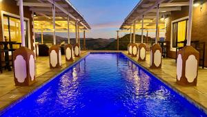 a swimming pool at a resort with a view at River Crossing Lodge in Windhoek