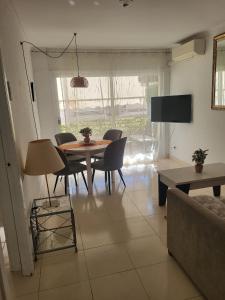 a living room with a table and chairs and a tv at ESPIGALL in Vilanova i la Geltrú