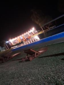 a boat sitting on the grass at night at Paraíso Yapeyu in Yapeyú