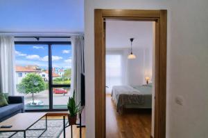 a bedroom with a bed and a large window at Llanes Celorio Piscina y Playa – El Castro Borizu in Celorio +29 photos