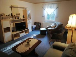 a living room with a couch and a tv at Apartment Sayda 4 in Sayda