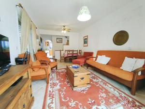 a living room with a couch and a table at Sunset View in Polis Chrysochous
