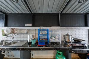 a kitchen with a sink and a counter top at Flamingo Na Jomtien in Na Jomtien