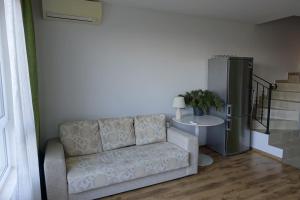 a living room with a couch and a table at Large Two Floor Apartment in Byala +3 photos