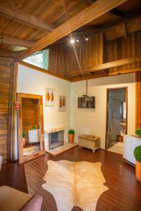 a living room with a large rug on the floor at Pousada Fazenda Caetés in Camboriú