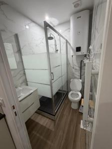 a small bathroom with a toilet and a shower at STUDIO deux NEUF A CROSNE in Crosne