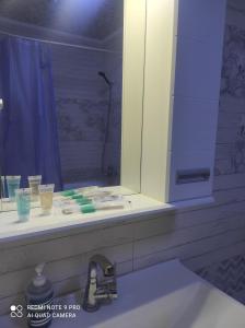 a bathroom counter with a sink and a mirror at высотка 15 in Aktobe