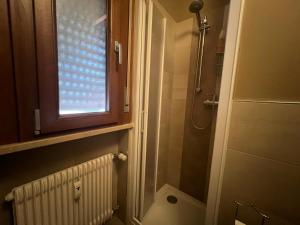 a bathroom with a toilet and a window at Pegaso - bilocale a pochi passi dal centro in Pordenone