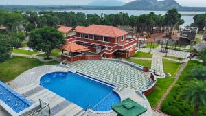 an aerial view of a house with a swimming pool at Palm Cove Resort And Spa in Jāmb