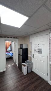 a room with a kitchen with a refrigerator and a door at Private 1BR Near Boston -- Kitchen & Laundry in Malden