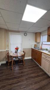 a kitchen with a table and chairs in a room at Private 1BR Near Boston -- Kitchen & Laundry in Malden