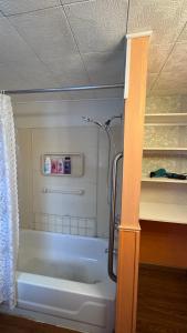 a bathroom with a bath tub in a room at Private 1BR Near Boston -- Kitchen & Laundry in Malden +2 photos