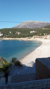 a view of a beach with a mountain in the background at Apartmani Primorski hrast in Bar