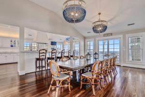 a kitchen and dining room with a table and chairs at Frankly My Dear - Duck, Oceanfront, Elevator, Wheelchair Friendly, Pool Table, Pool, Hot Tub, Flex Stays in Duck