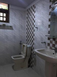 a bathroom with a toilet and a sink at Slayan properties in Gampaha