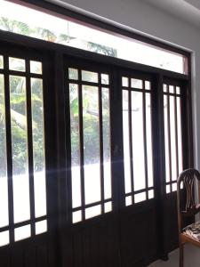 a sliding glass door withwindows in a room at Slayan properties in Gampaha
