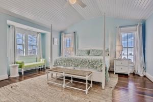 a bedroom with a canopy bed and a rug at Frankly My Dear - Duck, Oceanfront, Elevator, Wheelchair Friendly, Pool Table, Pool, Hot Tub, Flex Stays in Duck +52 photos