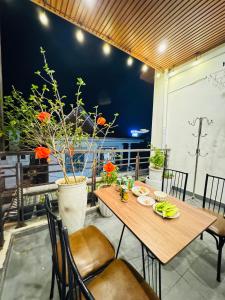 a wooden table and chairs on a patio at Tue Anh Homestay in Cồn Giả Viên