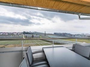 an office with a view of a field from a window at Ferienhof Raither in Immenstaad am Bodensee