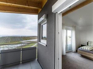 a bedroom with a bed and a view of a field at Ferienhof Raither in Immenstaad am Bodensee