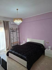 a bedroom with a large bed with a black blanket at La sirena in Mazara del Vallo
