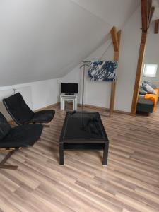 a living room with a coffee table and a couch at Maisonette with large terrace in Leipzig