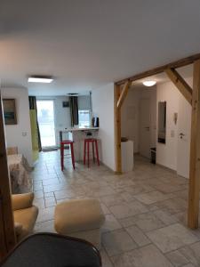 a living room with a table and a kitchen at Maisonette with large terrace in Leipzig