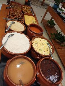 a table topped with lots of different types of food at Pousada Ilha Vitoria in Ubatuba